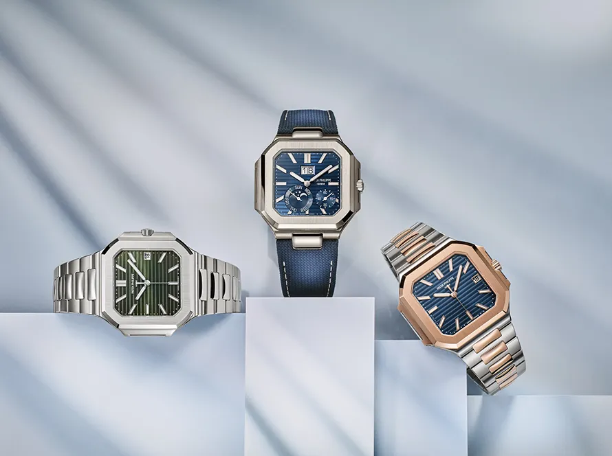 Three Cubitus 5821‑1A‑001 Patek Philippe timepieces in steel, rose‑gold, and blue‑strap finishes displayed on geometric pedestals – replica patek